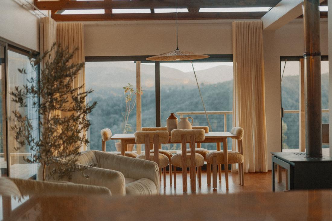 Dining table and sheepskin chairs against the mountains