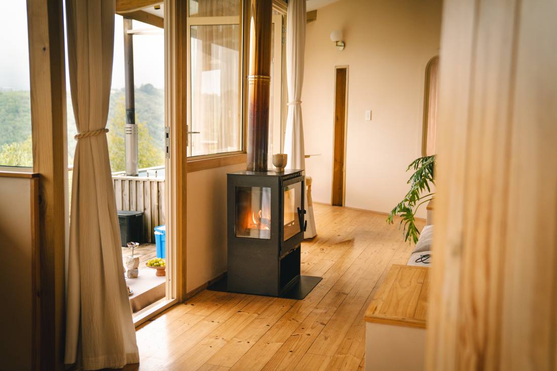 Fireplace beside open doors onto the deck